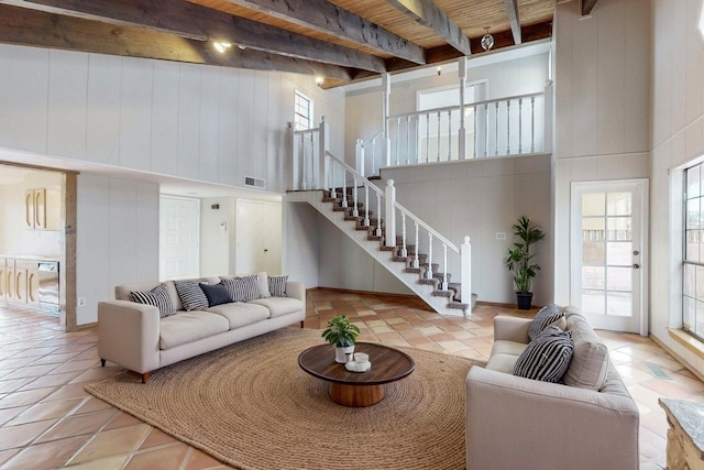 9815 Osuna Rd NE, Albuquerque, NM 87111 - tiled living area featuring a high ceiling, stairs, and a wood ceiling with exposed beams