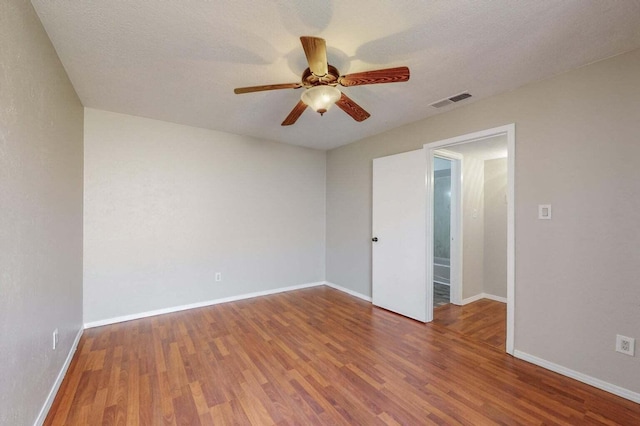 9815 Osuna Rd NE, Albuquerque, NM 87111 - empty room with a ceiling fan, wood finished floors, and a textured ceiling