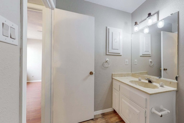 9815 Osuna Rd NE, Albuquerque, NM 87111 - bathroom featuring wood finished floors, vanity, and a textured wall