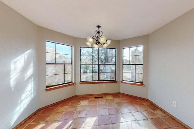 9815 Osuna Rd NE, Albuquerque, NM 87111 - spare room with healthy amount of natural light, a chandelier, and light tile patterned floors