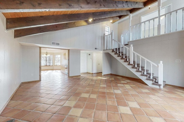9815 Osuna Rd NE, Albuquerque, NM 87111 - unfurnished living room featuring high vaulted ceiling, a wood ceiling with exposed beams, stairs, and tile patterned flooring