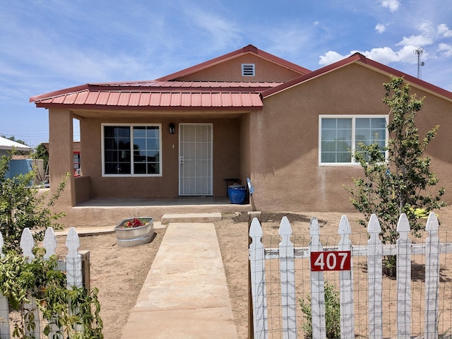 407 N Ripley Ave, Mountainair, NM 87036 - view of front facade with stucco siding and a metal roof