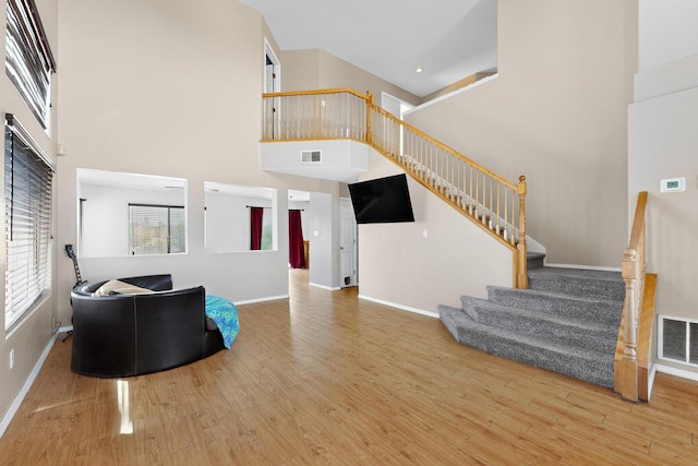 4249 Montera Pl NW, Albuquerque, NM 87114 - living area featuring a high ceiling, wood finished floors, and stairway