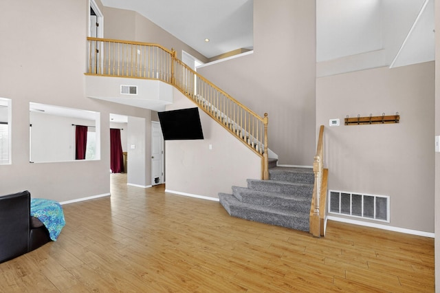 4249 Montera Pl NW, Albuquerque, NM 87114 - living room with stairway, wood finished floors, and a towering ceiling