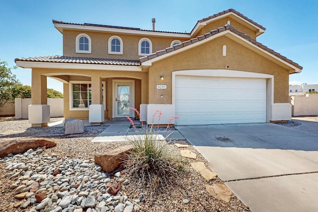 4249 Montera Pl NW, Albuquerque, NM 87114 - view of front of house with stucco siding, driveway, a tiled roof, and an attached garage
