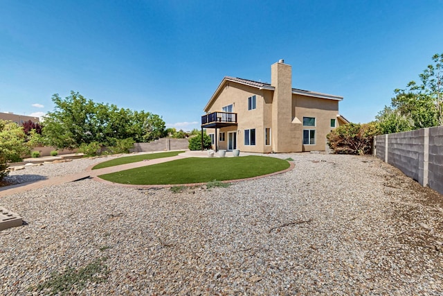 4249 Montera Pl NW, Albuquerque, NM 87114 - rear view of property featuring stucco siding, a chimney, a fenced backyard, a patio area, and a balcony