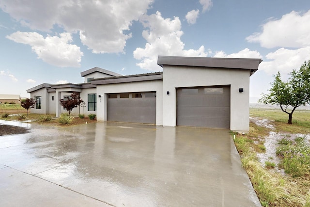 53 Blanco Dr, Edgewood, NM 87015 - contemporary house featuring an attached garage, stucco siding, and concrete driveway