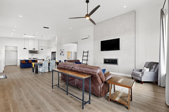53 Blanco Dr, Edgewood, NM 87015 - living area with a ceiling fan, light wood-style floors, a towering ceiling, recessed lighting, and a fireplace