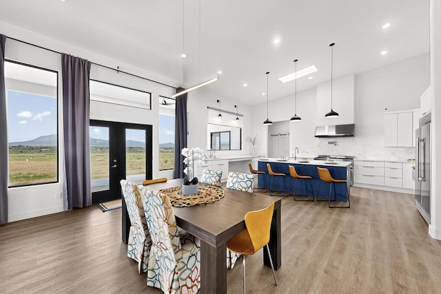 53 Blanco Dr, Edgewood, NM 87015 - dining room with a towering ceiling, light wood finished floors, recessed lighting, and french doors