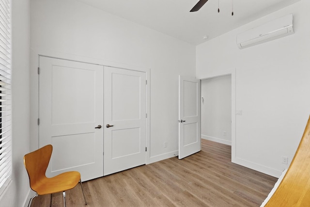53 Blanco Dr, Edgewood, NM 87015 - unfurnished bedroom with a wall mounted AC, light wood-type flooring, a closet, and a ceiling fan