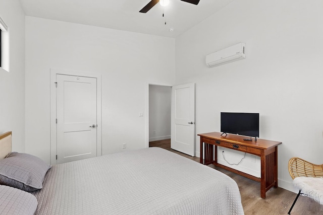 53 Blanco Dr, Edgewood, NM 87015 - bedroom featuring a wall mounted air conditioner, wood finished floors, a towering ceiling, and a ceiling fan