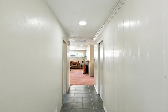 411 Schmidt Pl, Los Lunas, NM 87031 - corridor with dark tile patterned floors and dark colored carpet