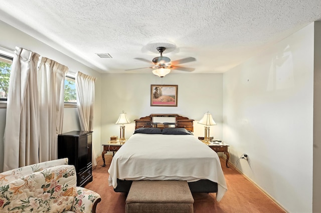 411 Schmidt Pl, Los Lunas, NM 87031 - bedroom with light colored carpet, a textured ceiling, and ceiling fan