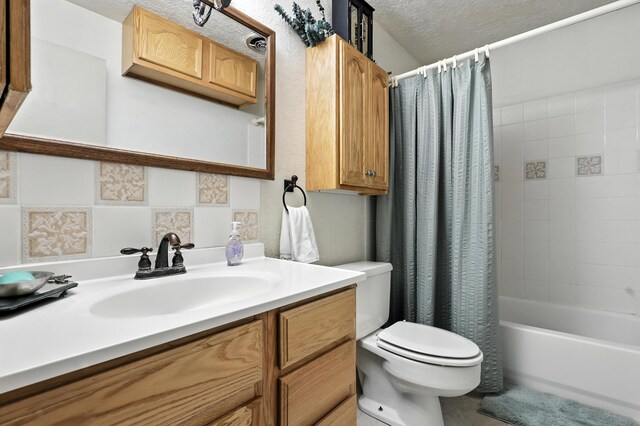 411 Schmidt Pl, Los Lunas, NM 87031 - bathroom featuring a textured ceiling, vanity, and shower / bath combo with shower curtain