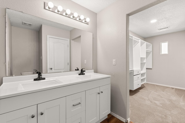 716 Palo Duro Dr, Bernalillo, NM 87004 - bathroom with double vanity and a textured ceiling