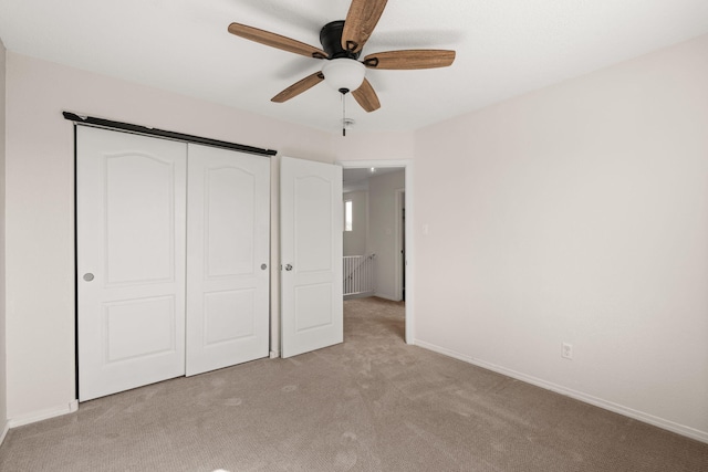 716 Palo Duro Dr, Bernalillo, NM 87004 - unfurnished bedroom featuring light carpet, a closet, and a ceiling fan