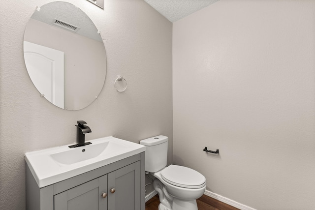 716 Palo Duro Dr, Bernalillo, NM 87004 - half bath with vanity, wood finished floors, and a textured ceiling