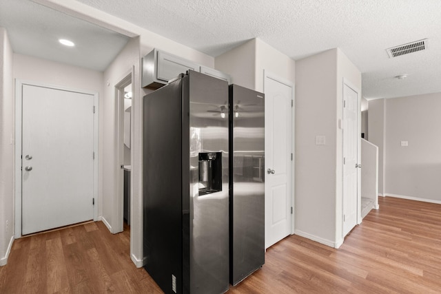 716 Palo Duro Dr, Bernalillo, NM 87004 - kitchen featuring stainless steel refrigerator with ice dispenser, light wood-style flooring, and a textured ceiling