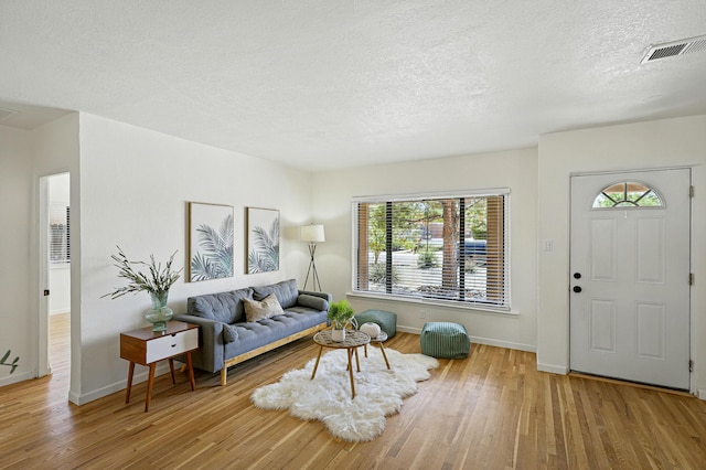 1202 Truman St SE, Albuquerque, NM 87108 - living area with wood finished floors, healthy amount of natural light, and a textured ceiling