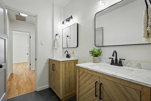 1202 Truman St SE, Albuquerque, NM 87108 - full bathroom with two vanities and baseboards