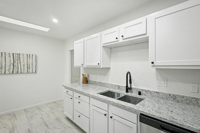 1202 Truman St SE, Albuquerque, NM 87108 - kitchen with stainless steel dishwasher, white cabinetry, light stone countertops, light marble finish floors, and recessed lighting