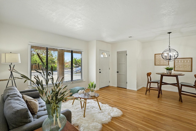 1202 Truman St SE, Albuquerque, NM 87108 - living area with light wood-style flooring and a chandelier
