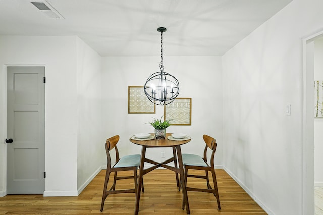 1202 Truman St SE, Albuquerque, NM 87108 - dining area with wood finished floors and a chandelier