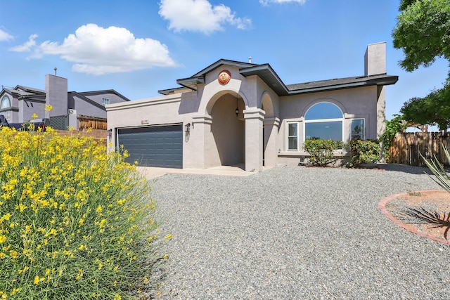2198 Lema Rd SE, Rio Rancho, NM 87124 - mediterranean / spanish-style house featuring an attached garage, stucco siding, and driveway