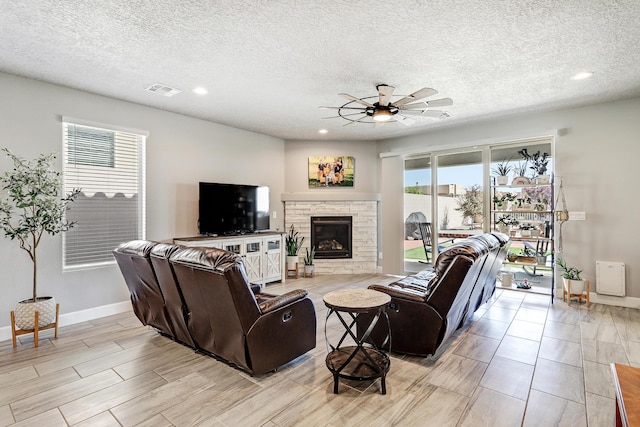 2530 Guadalupe Rd NE, Rio Rancho, NM 87144 - living area featuring ceiling fan, recessed lighting, a fireplace, wood finish floors, and a textured ceiling