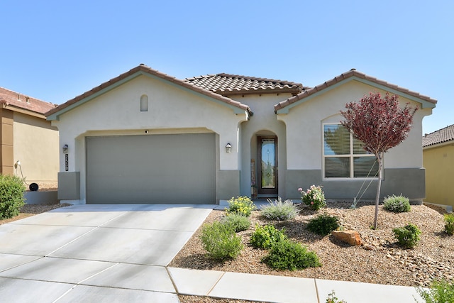 2530 Guadalupe Rd NE, Rio Rancho, NM 87144 - mediterranean / spanish home featuring a garage, stucco siding, driveway, and a tile roof