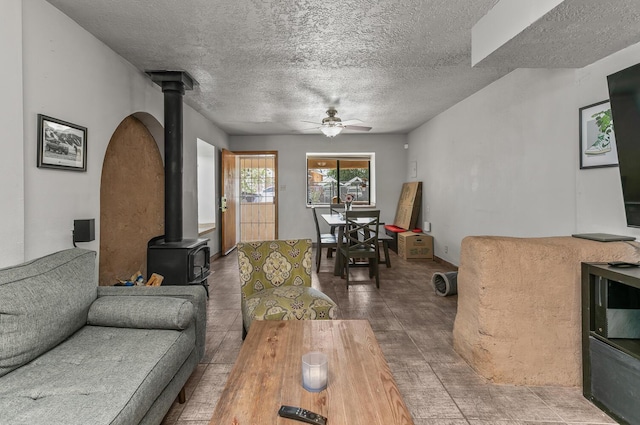 1405 3rd St SW, Albuquerque, NM 87102 - living room featuring a wood stove, a ceiling fan, and a textured ceiling
