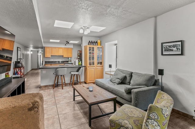 1405 3rd St SW, Albuquerque, NM 87102 - living room with a skylight, a textured ceiling, and light tile patterned floors