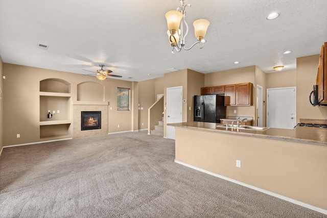 1717 Cortina Loop SE, Rio Rancho, NM 87124 - kitchen with black appliances, brown cabinets, built in features, light carpet, and a ceiling fan