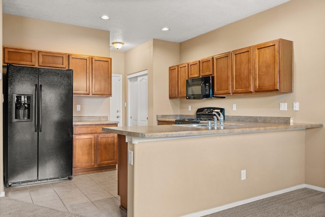 1717 Cortina Loop SE, Rio Rancho, NM 87124 - kitchen featuring black appliances, a peninsula, brown cabinetry, light countertops, and recessed lighting
