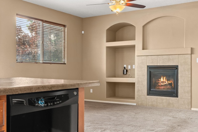 1717 Cortina Loop SE, Rio Rancho, NM 87124 - unfurnished living room with built in features, carpet flooring, ceiling fan, and a tiled fireplace