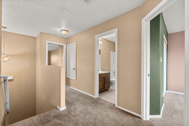 1717 Cortina Loop SE, Rio Rancho, NM 87124 - corridor featuring an upstairs landing, light colored carpet, and a textured ceiling