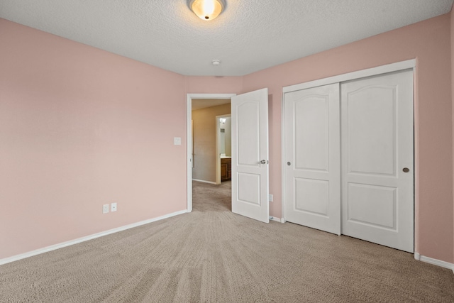 1717 Cortina Loop SE, Rio Rancho, NM 87124 - unfurnished bedroom featuring carpet floors, a textured ceiling, and a closet