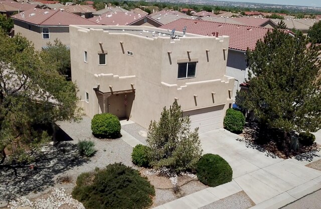 7527 Cricket Hill Dr NE, Albuquerque, NM 87113 - kitchen featuring stainless steel gas stove, exhaust hood, a peninsula, light countertops, and dark wood-style floors