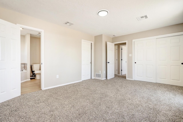 1004 11th St SE, Rio Rancho, NM 87124 - unfurnished bedroom with carpet, connected bathroom, and a closet