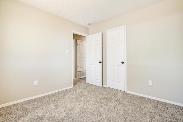 1004 11th St SE, Rio Rancho, NM 87124 - unfurnished bedroom featuring light carpet and baseboards