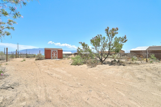 1004 11th St SE, Rio Rancho, NM 87124 - view of yard featuring a shed and a mountain view