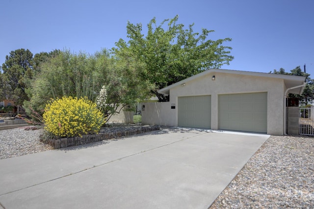 1733 Luthy Dr NE, Albuquerque, NM 87112 - view of front of house featuring stucco siding, an attached garage, and concrete driveway