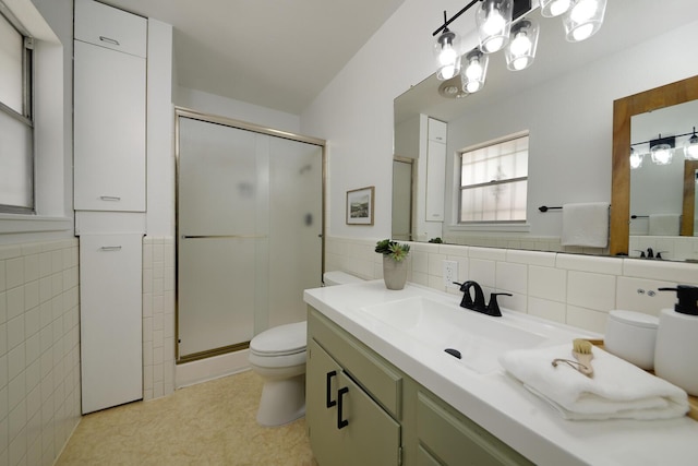 1733 Luthy Dr NE, Albuquerque, NM 87112 - full bathroom with tile walls, a stall shower, vanity, a wainscoted wall, and a chandelier