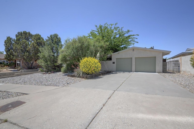 1733 Luthy Dr NE, Albuquerque, NM 87112 - view of side of home featuring stucco siding and a garage