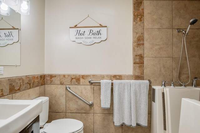 3921 Hilton Ave NE, Albuquerque, NM 87110 - full bathroom featuring tile walls, tub / shower combination, and a wainscoted wall
