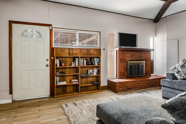 3921 Hilton Ave NE, Albuquerque, NM 87110 - living room featuring wood finished floors, beam ceiling, and a brick fireplace