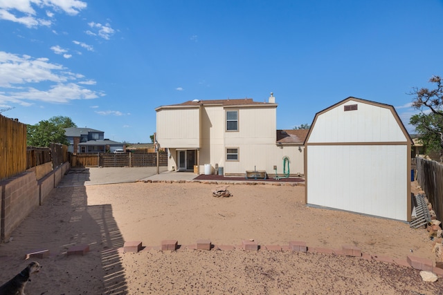 1897 Raspberry Ct NE, Rio Rancho, NM 87144 - rear view of house featuring an outbuilding, a fenced backyard, a patio area, and roof with shingles