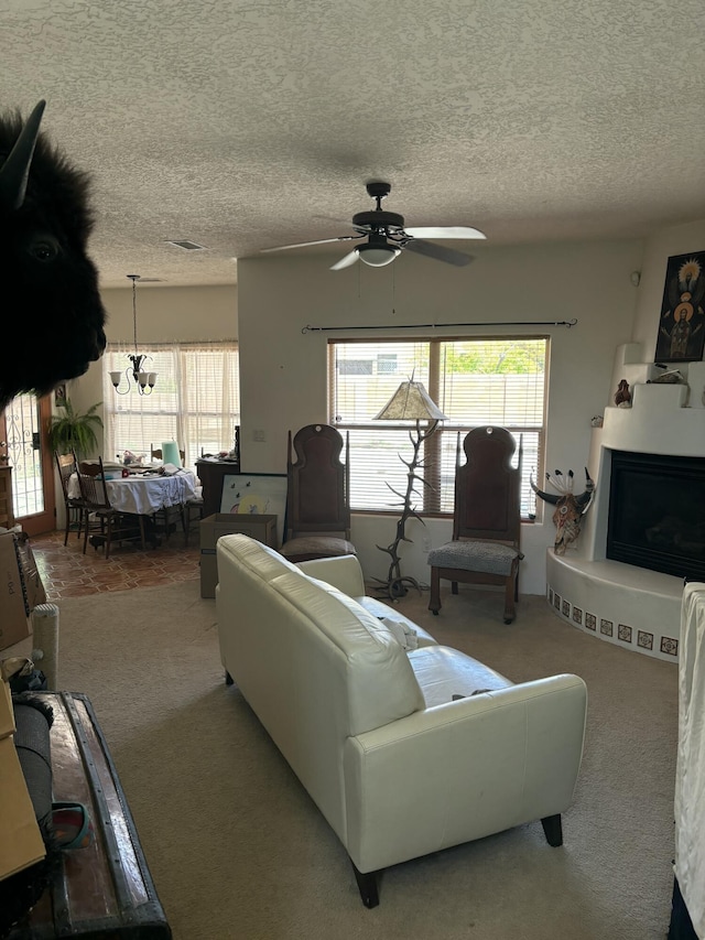 9523 Akutan Ct NW, Albuquerque, NM 87120 - living room with carpet flooring, ceiling fan, healthy amount of natural light, a textured ceiling, and a fireplace