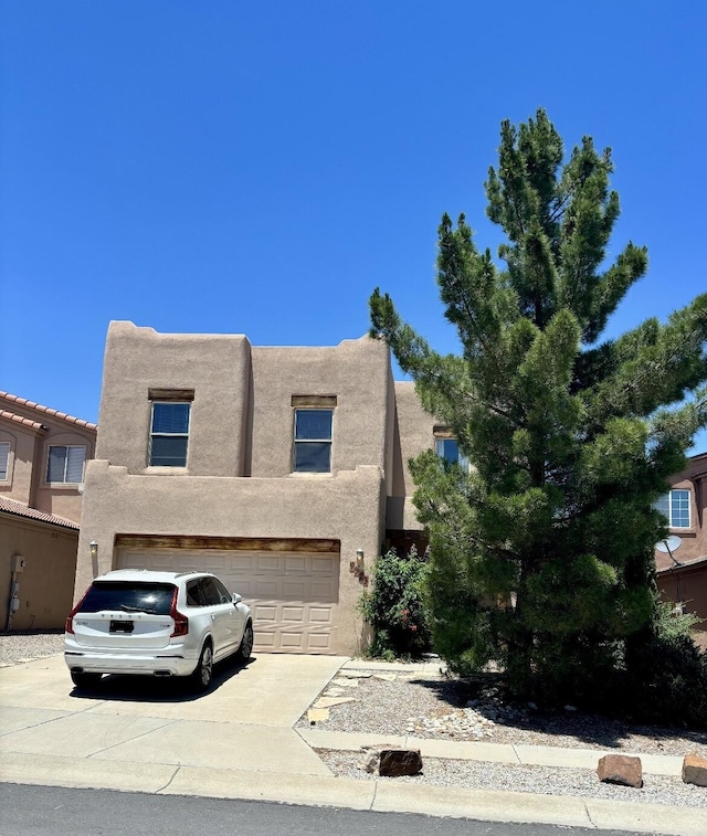 9523 Akutan Ct NW, Albuquerque, NM 87120 - southwest-style home with driveway, stucco siding, and a garage