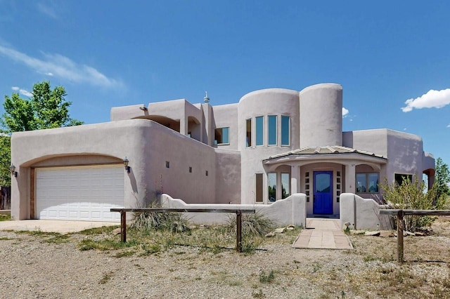10 Francisco Rd, Cedar Crest, NM 87008 - pueblo revival-style home featuring a garage, stucco siding, and driveway